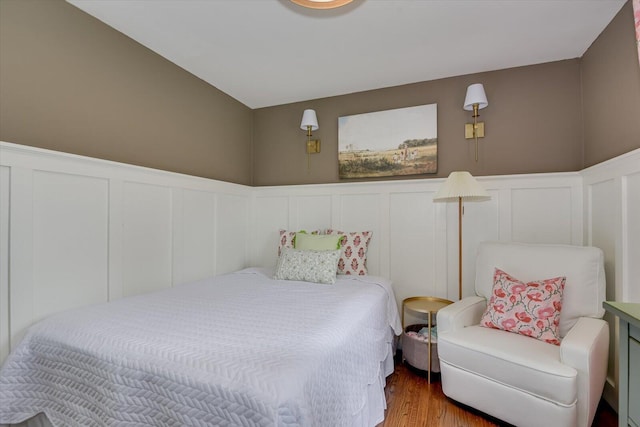 3122 Ramsgate Rd, Augusta, GA 30909 - bedroom featuring a decorative wall, wainscoting, and wood finished floors