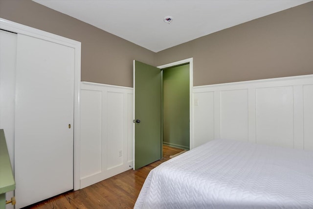 3122 Ramsgate Rd, Augusta, GA 30909 - bedroom with a decorative wall, dark wood finished floors, and wainscoting