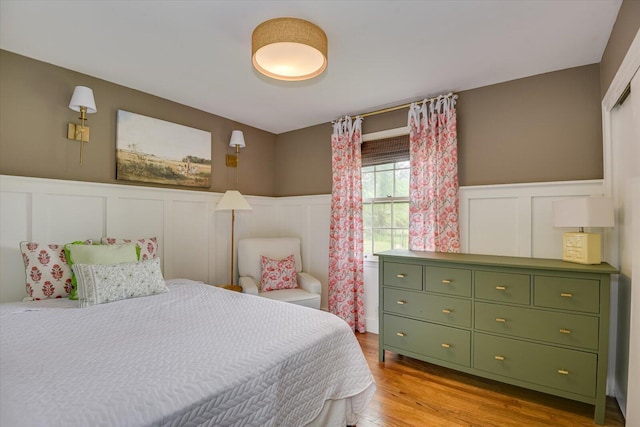 3122 Ramsgate Rd, Augusta, GA 30909 - bedroom with a decorative wall, a wainscoted wall, and wood finished floors