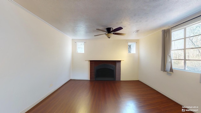 unfurnished living room featuring a textured ceiling, ceiling fan, a fireplace, and hardwood / wood-style floors