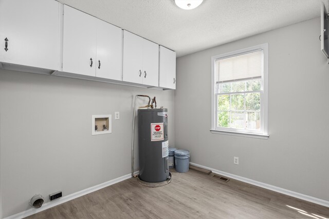 2638 Central Ave, Augusta, GA 30904 - laundry area with cabinet space, electric dryer hookup, visible vents, hookup for a washing machine, and electric water heater