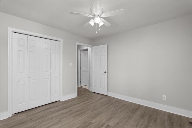 2638 Central Ave, Augusta, GA 30904 - unfurnished bedroom with baseboards, wood finished floors, a ceiling fan, and a closet
