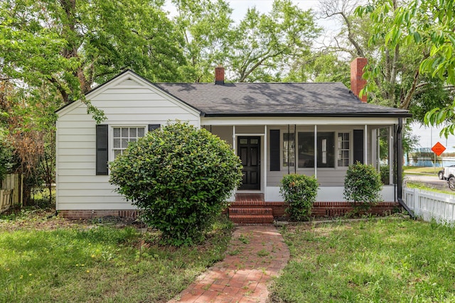 2638 Central Ave, Augusta, GA 30904 - view of front of home featuring a front yard, a shingled roof, and a chimney
