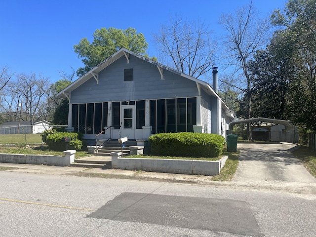view of front of house featuring a carport and a sunroom