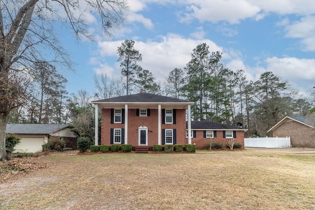 colonial-style house with a front lawn