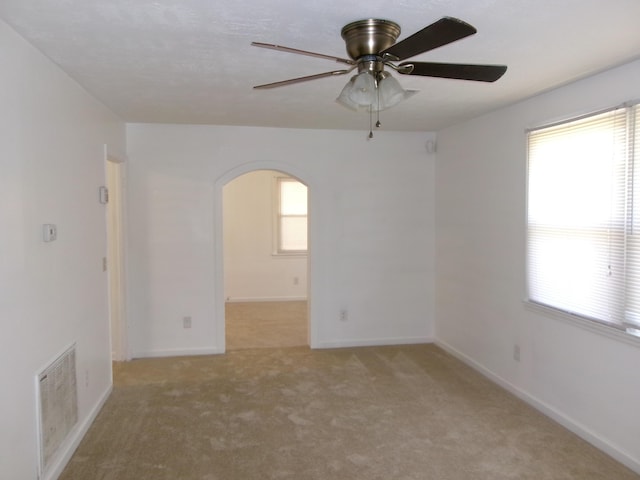 2524 Elderberry Dr, Augusta, GA 30906 - empty room with visible vents, baseboards, arched walkways, light carpet, and a ceiling fan