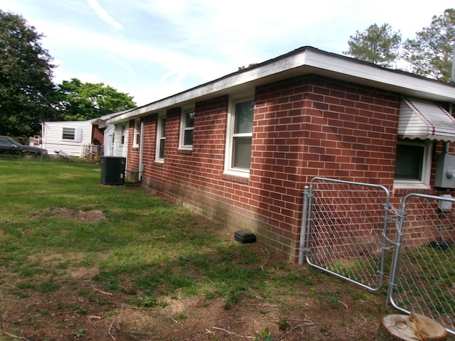 2524 Elderberry Dr, Augusta, GA 30906 - view of side of home featuring fence, central AC, a lawn, and brick siding