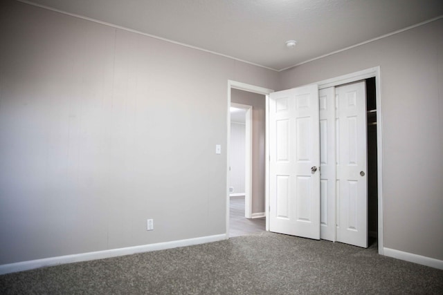 unfurnished bedroom with carpet floors and a closet