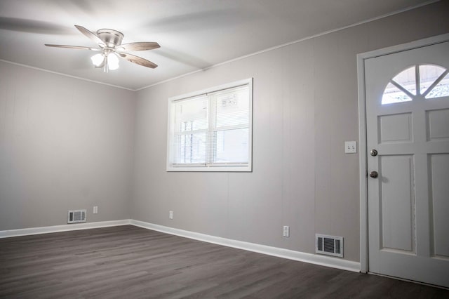 foyer entrance with crown molding, dark hardwood / wood-style floors, a wealth of natural light, and ceiling fan