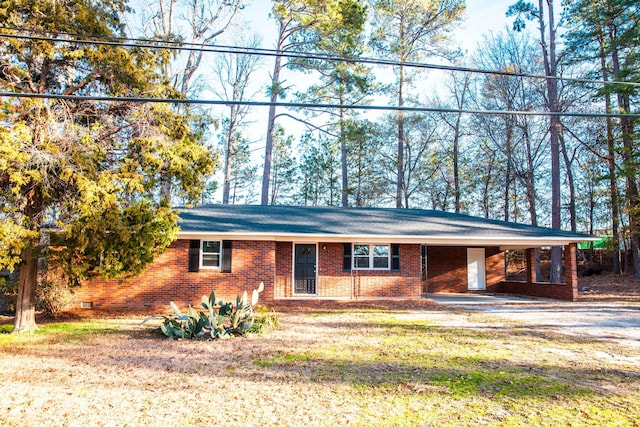 ranch-style home featuring a front yard and a carport