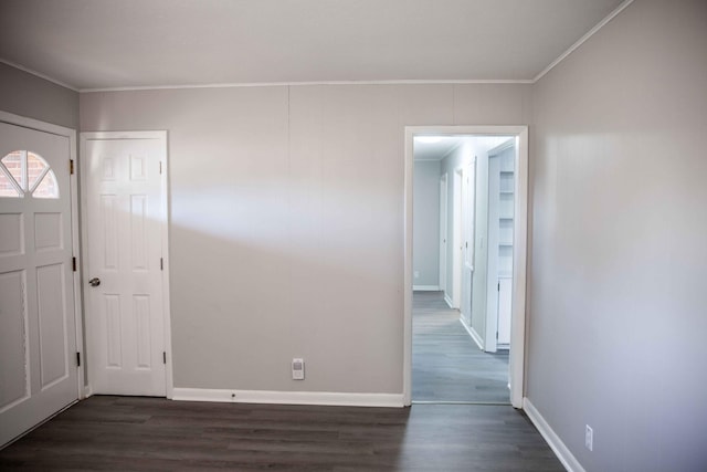 entrance foyer with dark wood-type flooring and ornamental molding