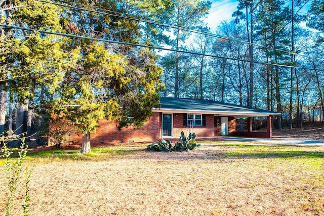 ranch-style house with a carport and a front lawn