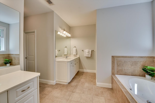 421 Armstrong Way, Evans, GA 30809 - bathroom featuring a garden tub, vanity, tile patterned flooring, and baseboards
