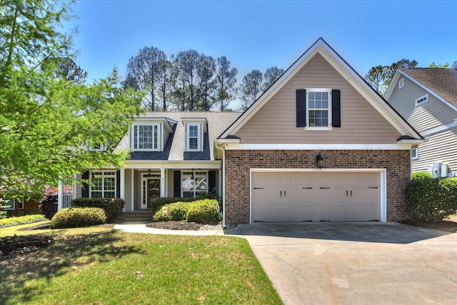 421 Armstrong Way, Evans, GA 30809 - view of front of property with concrete driveway, brick siding, a front yard, covered porch, and an attached garage