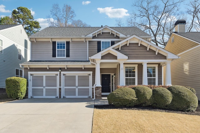 craftsman house with concrete driveway, roof with shingles, and an attached garage