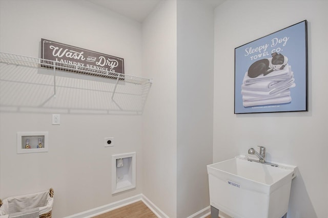 laundry area featuring electric dryer hookup, hookup for a washing machine, wood-type flooring, and sink