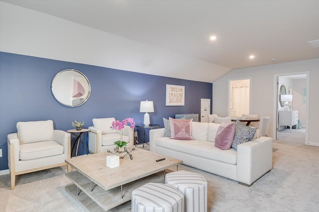 carpeted living room with lofted ceiling