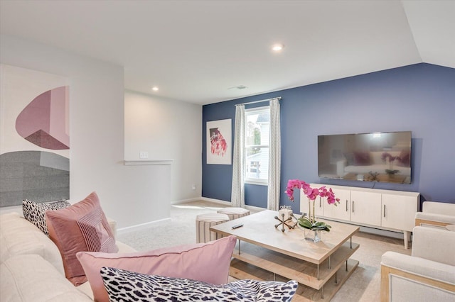 carpeted living room with vaulted ceiling