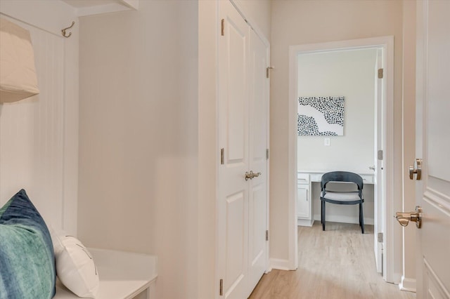 hallway with light hardwood / wood-style flooring