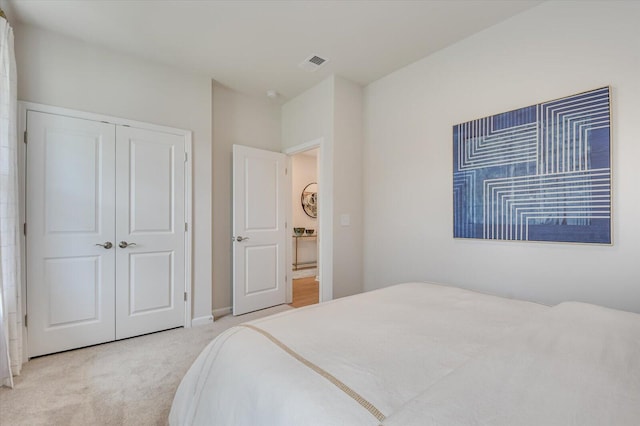 carpeted bedroom with a closet