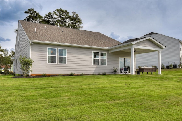 rear view of property featuring a patio, central air condition unit, and a lawn