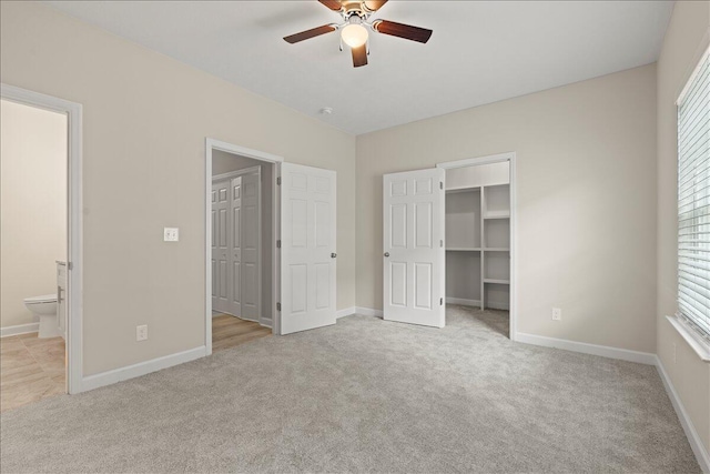 239 Walker St, Augusta, GA 30901 - unfurnished bedroom featuring light carpet, a walk in closet, ensuite bathroom, and baseboards