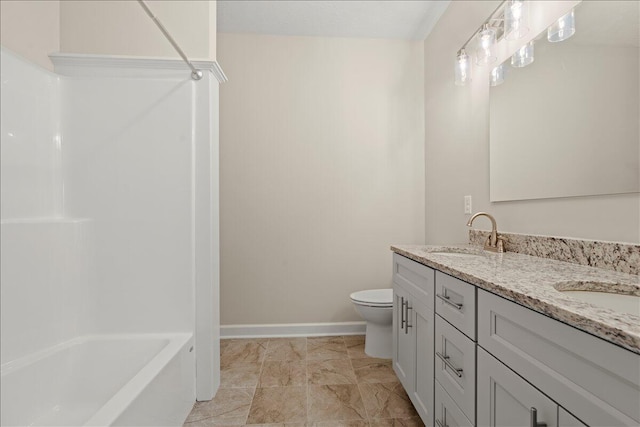 239 Walker St, Augusta, GA 30901 - bathroom with double vanity, baseboards, toilet, and washtub / shower combination