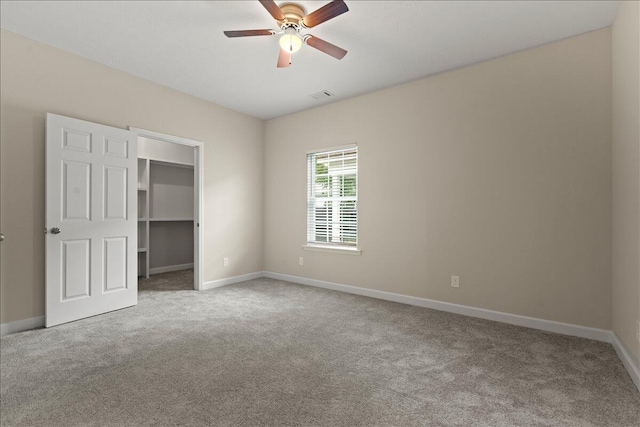 239 Walker St, Augusta, GA 30901 - unfurnished bedroom with carpet floors, baseboards, a walk in closet, a ceiling fan, and a closet