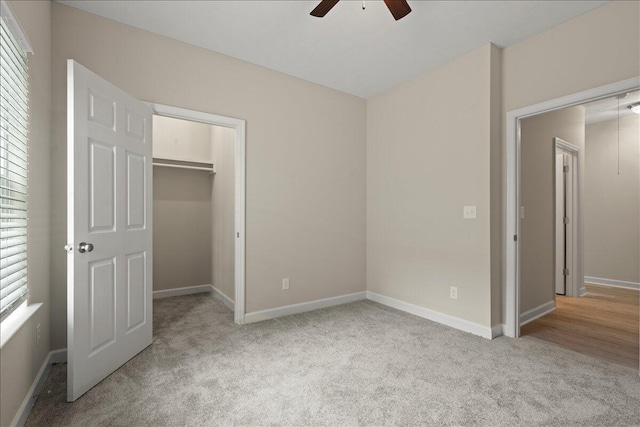 239 Walker St, Augusta, GA 30901 - unfurnished bedroom featuring carpet, a walk in closet, a closet, baseboards, and ceiling fan