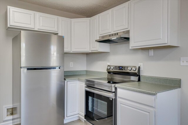 kitchen with under cabinet range hood, white cabinetry, and appliances with stainless steel finishes