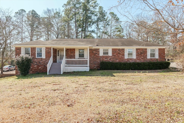 single story home featuring a porch and a front yard