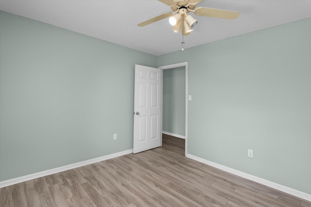 unfurnished room featuring ceiling fan and light wood-type flooring