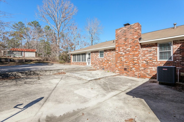 rear view of house featuring a patio and central AC unit