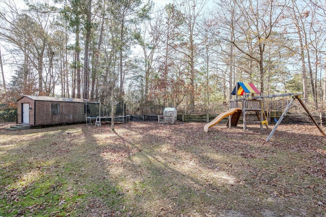 view of yard with a trampoline, a playground, and a storage unit