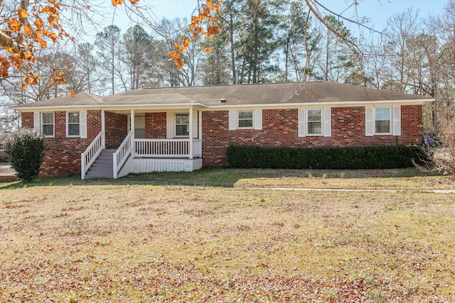 single story home featuring covered porch and a front yard