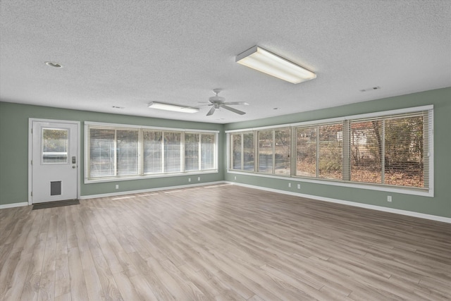 interior space with a textured ceiling, light hardwood / wood-style flooring, and ceiling fan