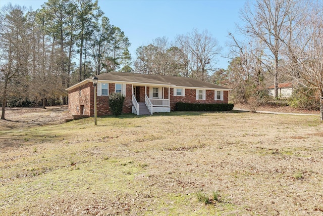 ranch-style house featuring a front lawn and a porch