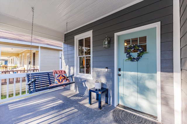 doorway to property featuring a porch