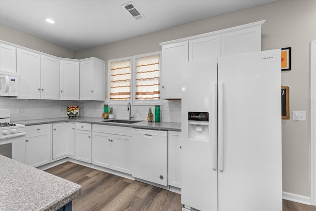 kitchen with white appliances, white cabinetry, and sink