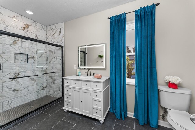 bathroom with walk in shower, tile patterned flooring, a textured ceiling, toilet, and vanity