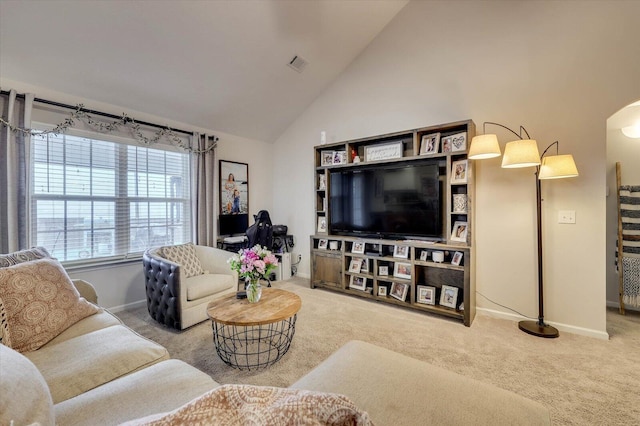 carpeted living room featuring high vaulted ceiling