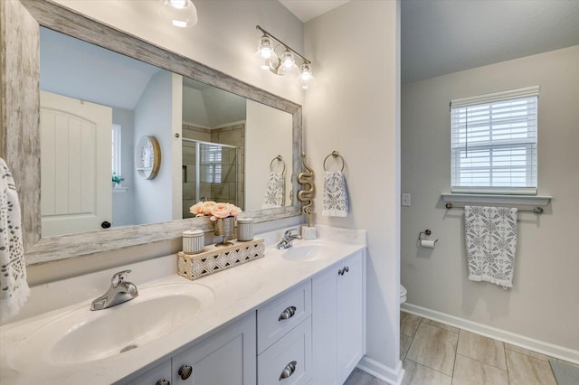 bathroom featuring tile patterned floors, toilet, vanity, and walk in shower