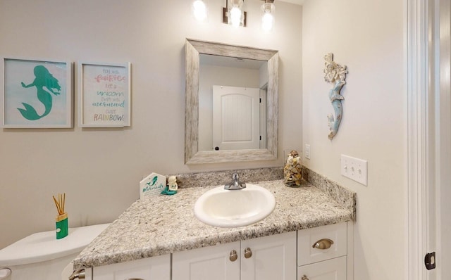 bathroom featuring vanity and toilet