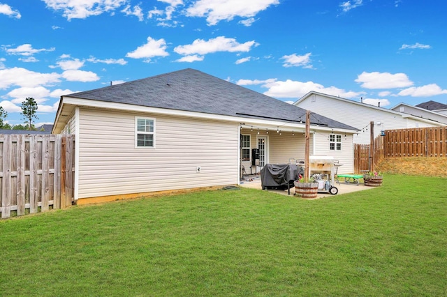 rear view of house featuring a patio area and a lawn