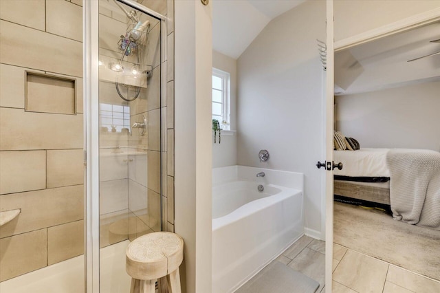 bathroom with plus walk in shower, tile patterned floors, and vaulted ceiling