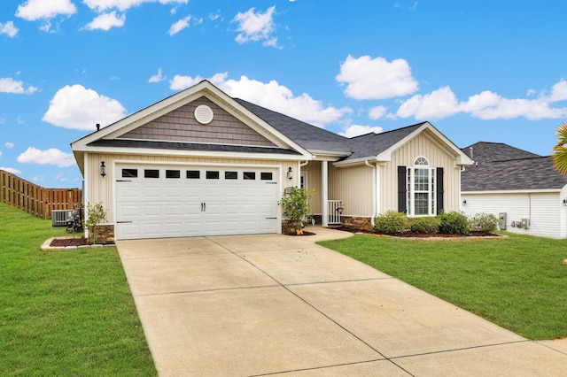 view of front facade with central AC, a garage, and a front lawn