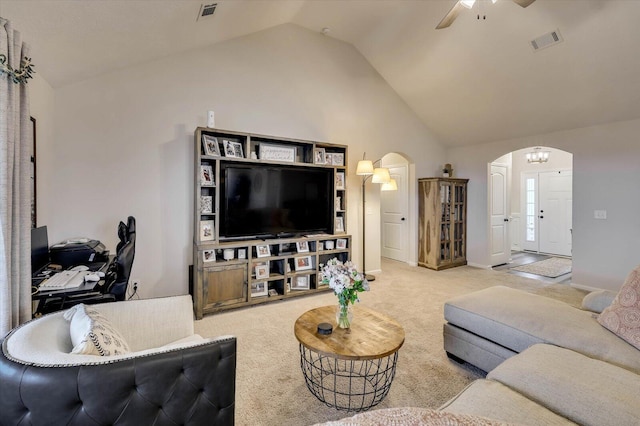 living room featuring light carpet, ceiling fan with notable chandelier, and lofted ceiling