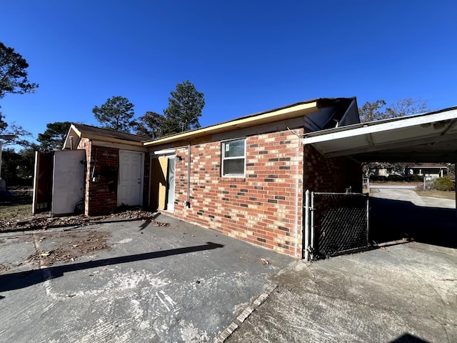 view of property exterior featuring a carport