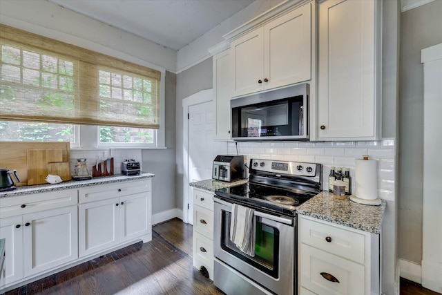 1202 Hickman Rd, Augusta, GA 30904 - kitchen with appliances with stainless steel finishes, backsplash, light stone counters, dark wood-style floors, and baseboards