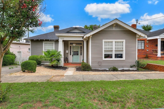 1202 Hickman Rd, Augusta, GA 30904 - bungalow-style home with a front lawn, a chimney, a porch, and a shingled roof